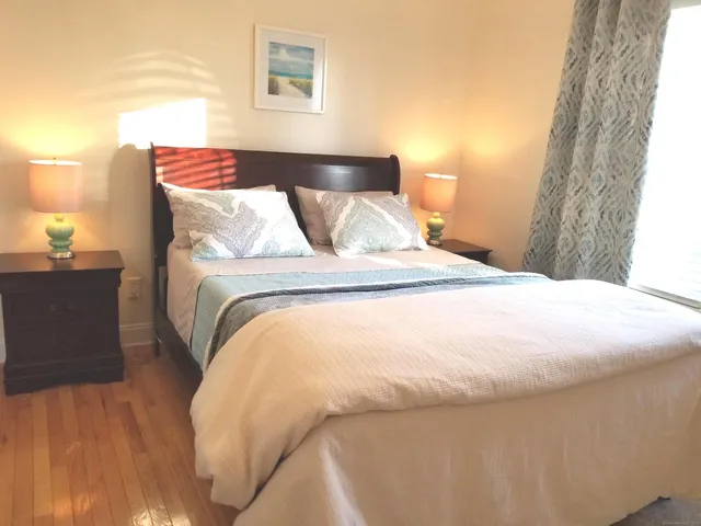 a bed sitting in a bedroom next to a window