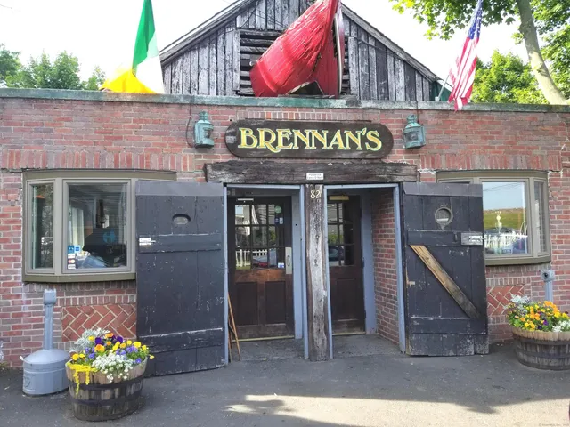 a view of swimming pool with a table and chairs under an umbrella