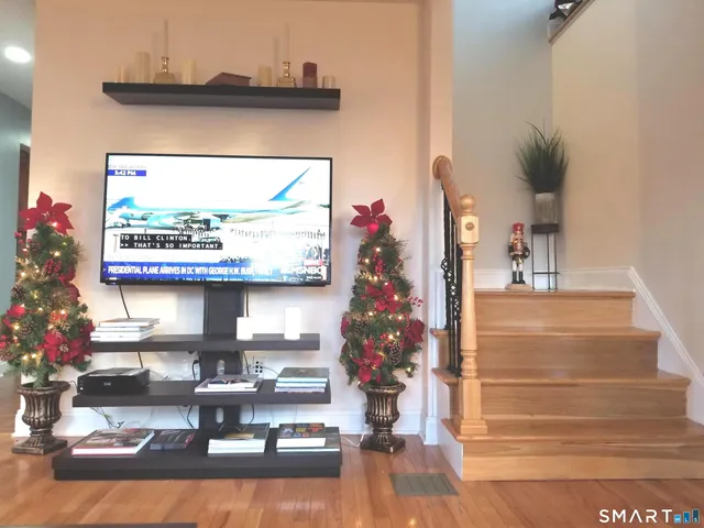 a room with lots of white furniture and a window