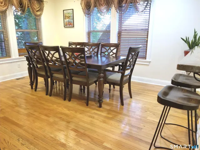 a view of a dining room with furniture and wooden floor