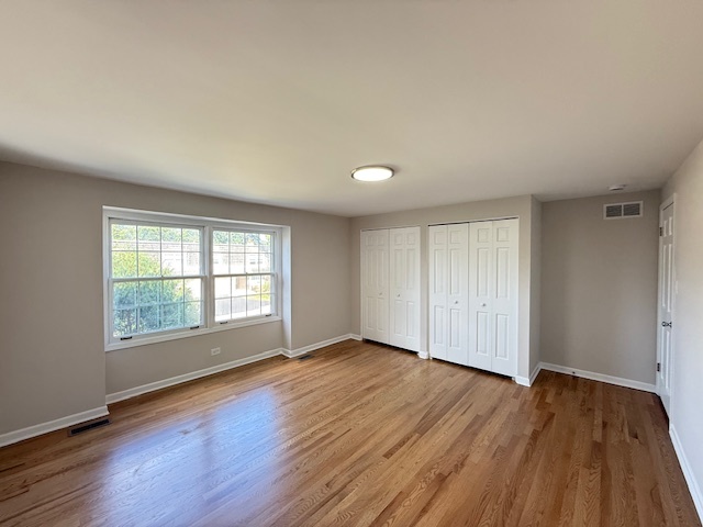 19W147 Ave Rue Royal Oak Brook, IL 60523 - Photo 11 of 16 an empty room with wooden floor and windows