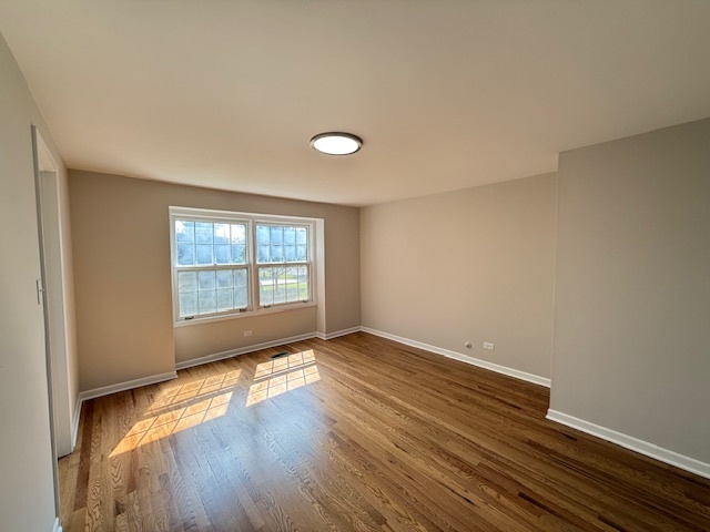 19W147 Ave Rue Royal Oak Brook, IL 60523 - Photo 13 of 16 a view of an empty room with wooden floor and a window