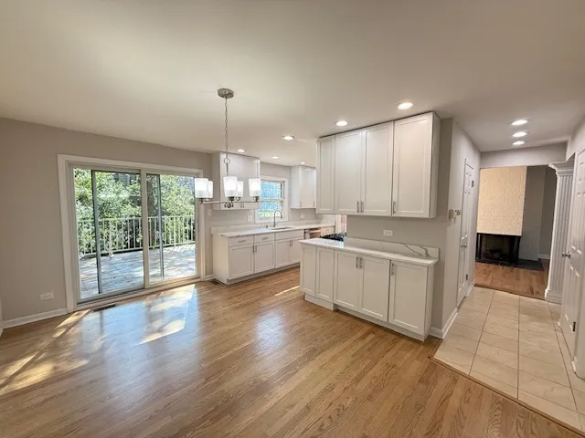 a large kitchen with a lot of counter space and a wooden floor