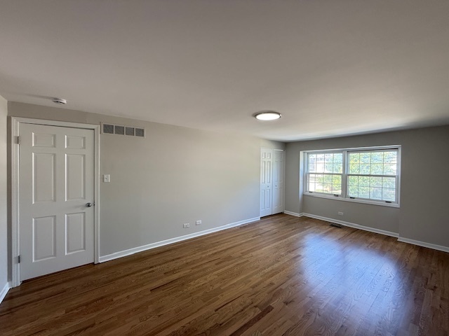 19W147 Ave Rue Royal Oak Brook, IL 60523 - Photo 8 of 16 an empty room with wooden floor and windows