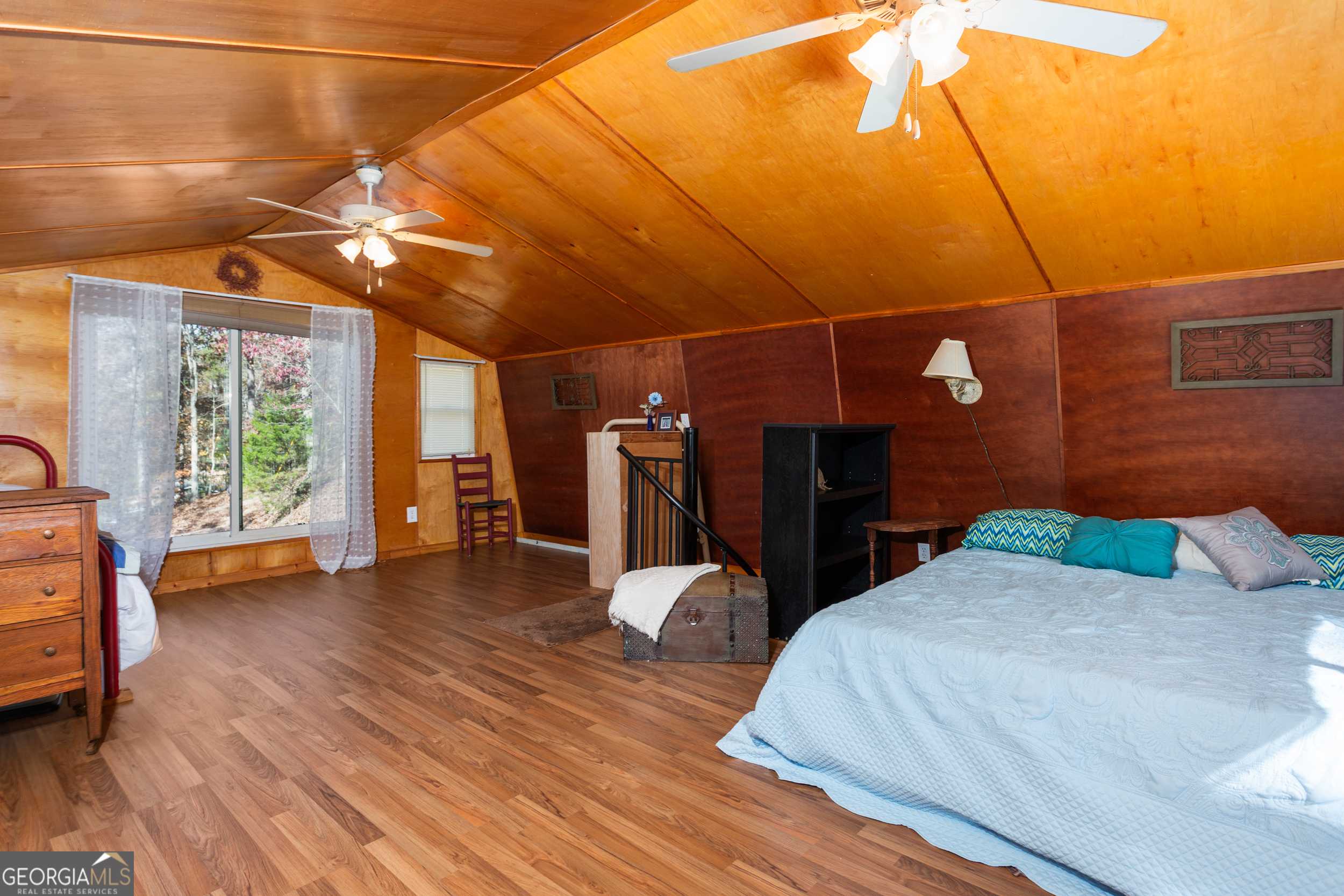 114 Lakeside Circle Delta, AL 36258 - Photo 13 of 22 a bedroom with a bed and wooden floor