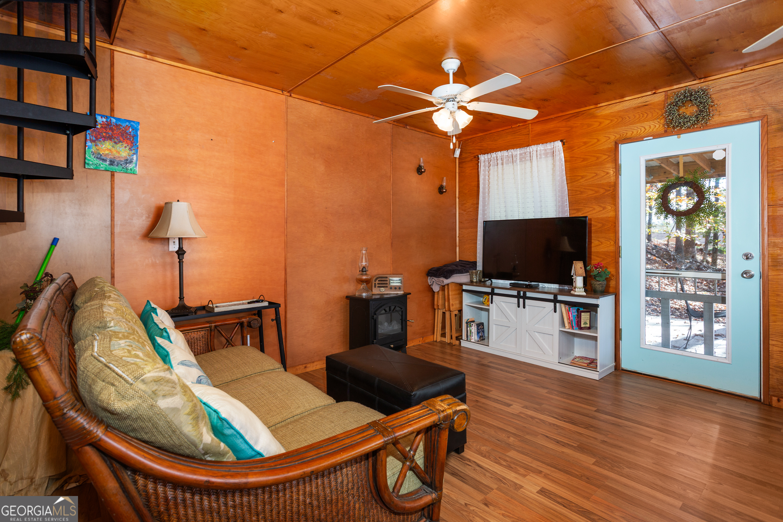 114 Lakeside Circle Delta, AL 36258 - Photo 3 of 22 a view of a livingroom with furniture a flat screen tv and floor to ceiling window