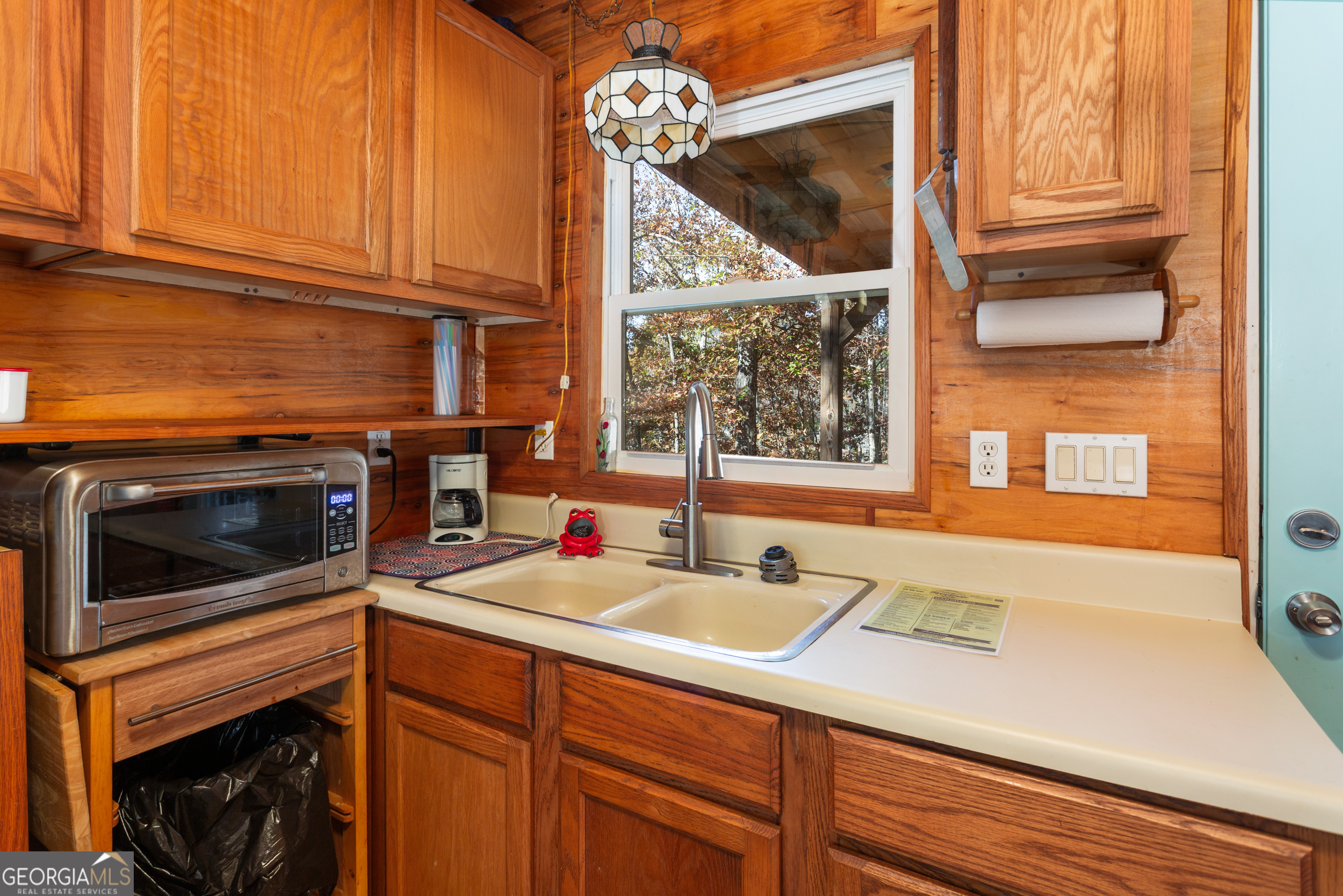 114 Lakeside Circle Delta, AL 36258 - Photo 8 of 22 a kitchen with a sink and a microwave