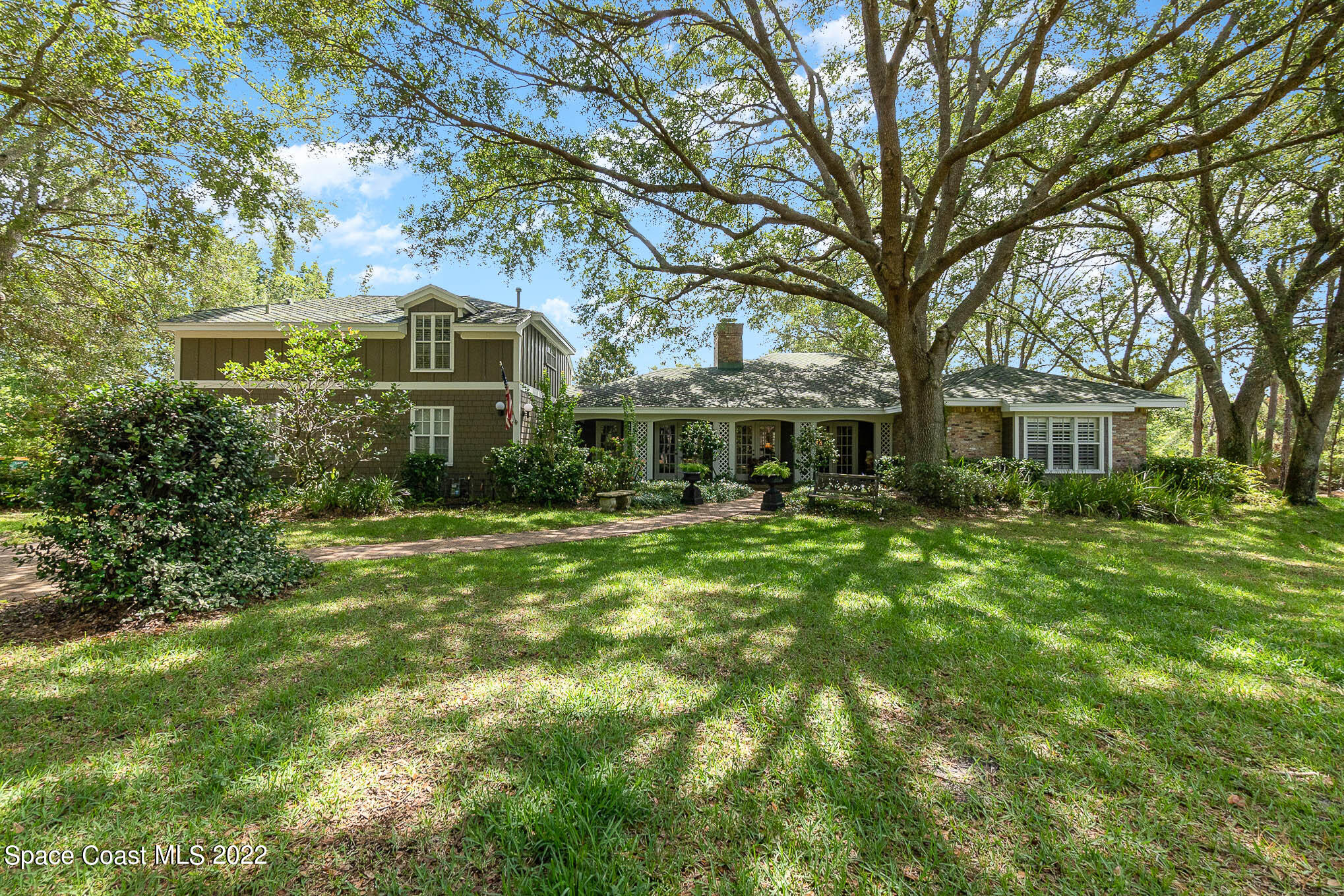4025 Turtle Mound Road Melbourne, FL 32934 - Photo 1 of 54 a front view of a house with a garden