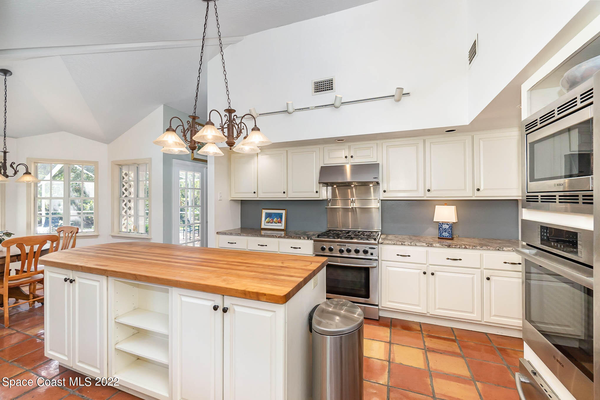 4025 Turtle Mound Road Melbourne, FL 32934 - Photo 11 of 54 a kitchen that has a lot of cabinets in it and a window