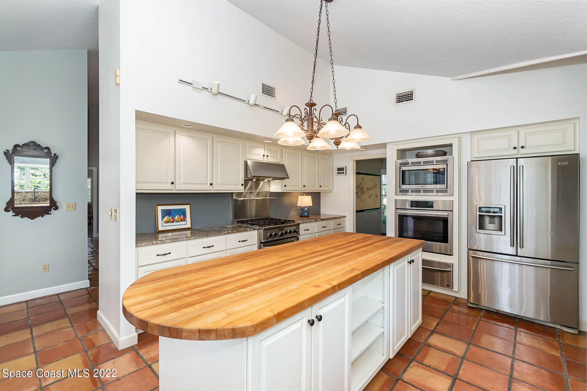 4025 Turtle Mound Road Melbourne, FL 32934 - Photo 12 of 54 a room with kitchen island a center island and stainless steel appliances