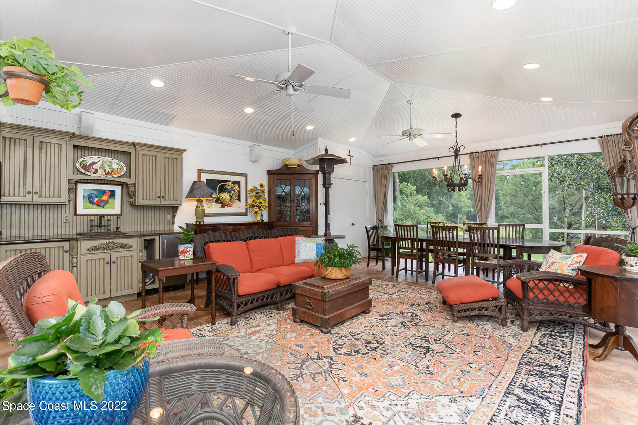 4025 Turtle Mound Road Melbourne, FL 32934 - Photo 15 of 54 a living room with furniture kitchen view and large windows
