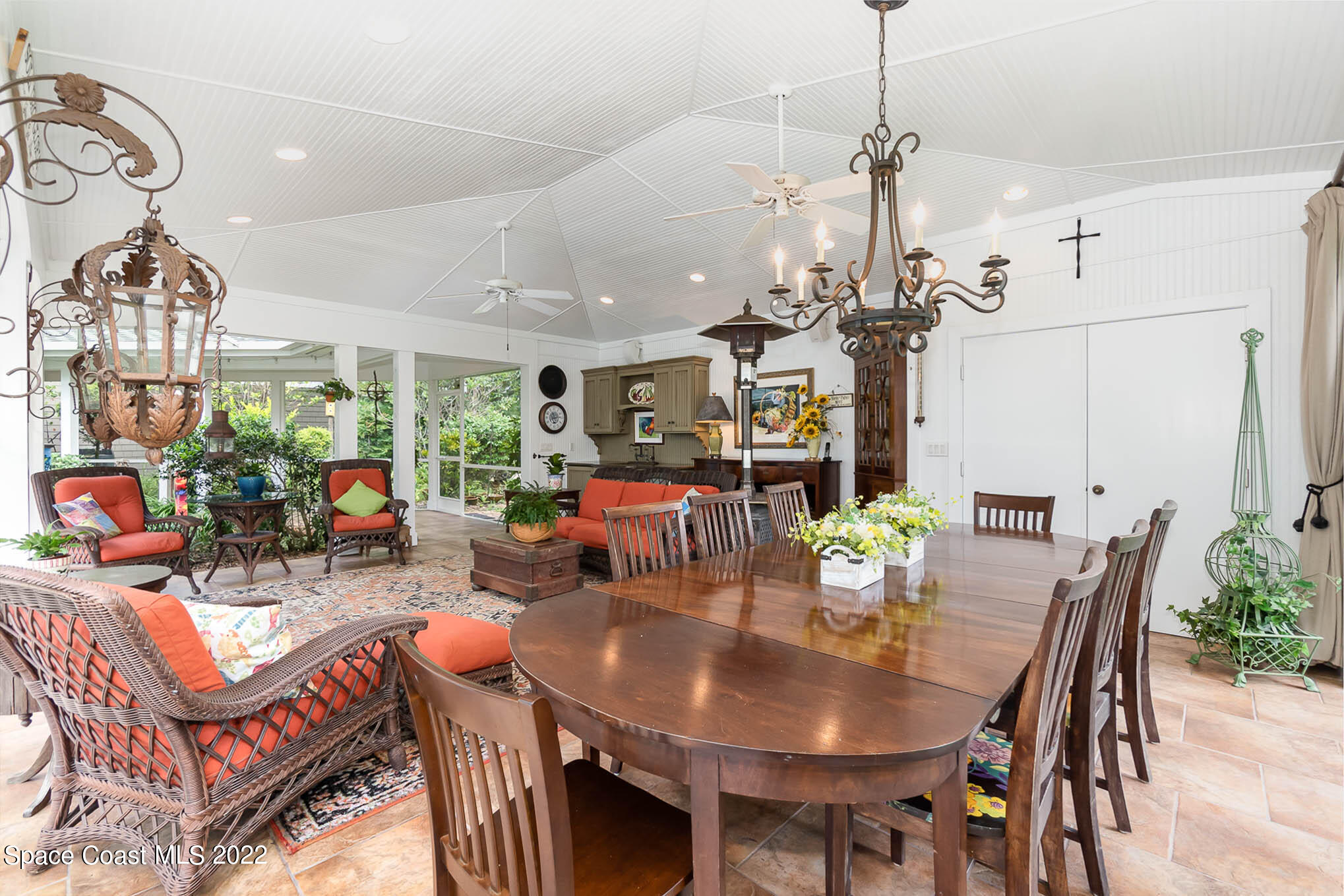 4025 Turtle Mound Road Melbourne, FL 32934 - Photo 16 of 54 a outdoor dining room with furniture a chandelier and a chandelier