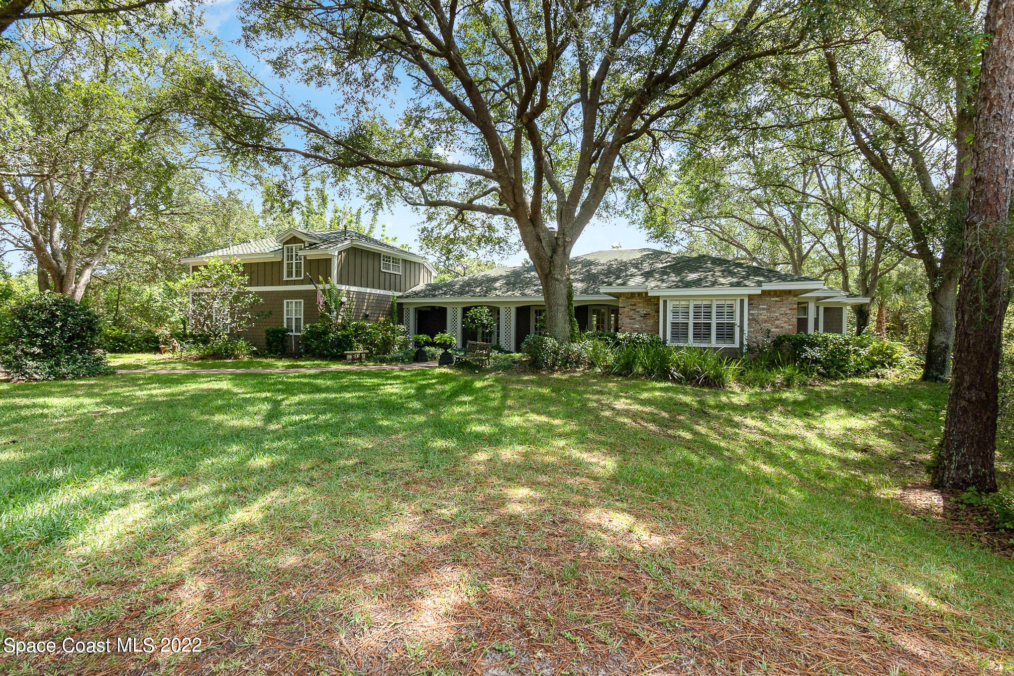 4025 Turtle Mound Road Melbourne, FL 32934 - Photo 2 of 54 a front view of a house with a yard