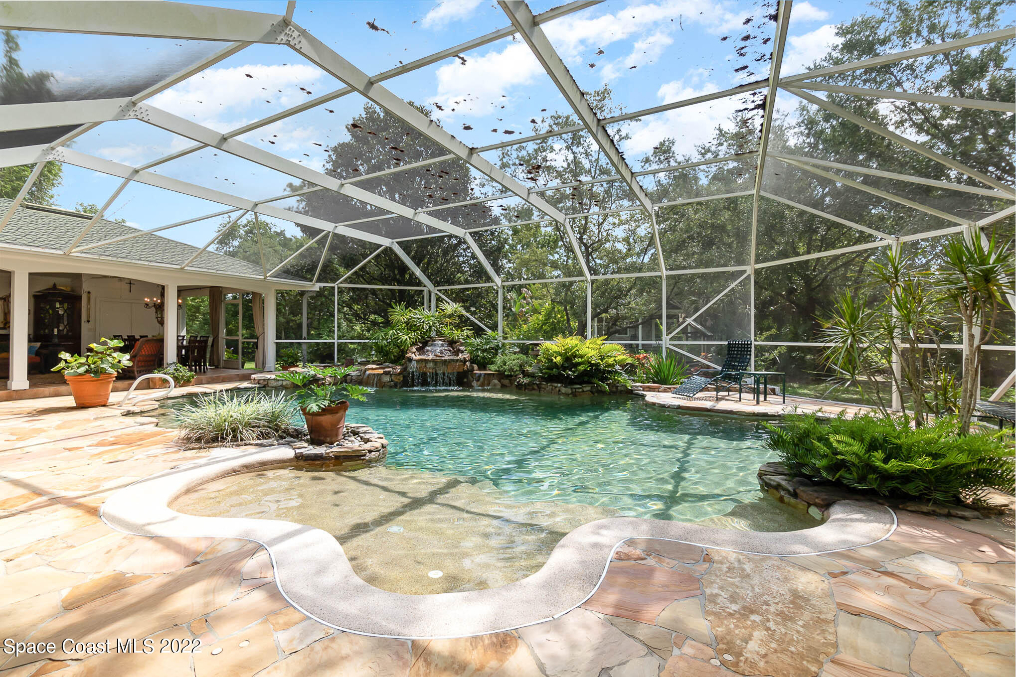 4025 Turtle Mound Road Melbourne, FL 32934 - Photo 21 of 54 a view of a backyard with plants and a patio