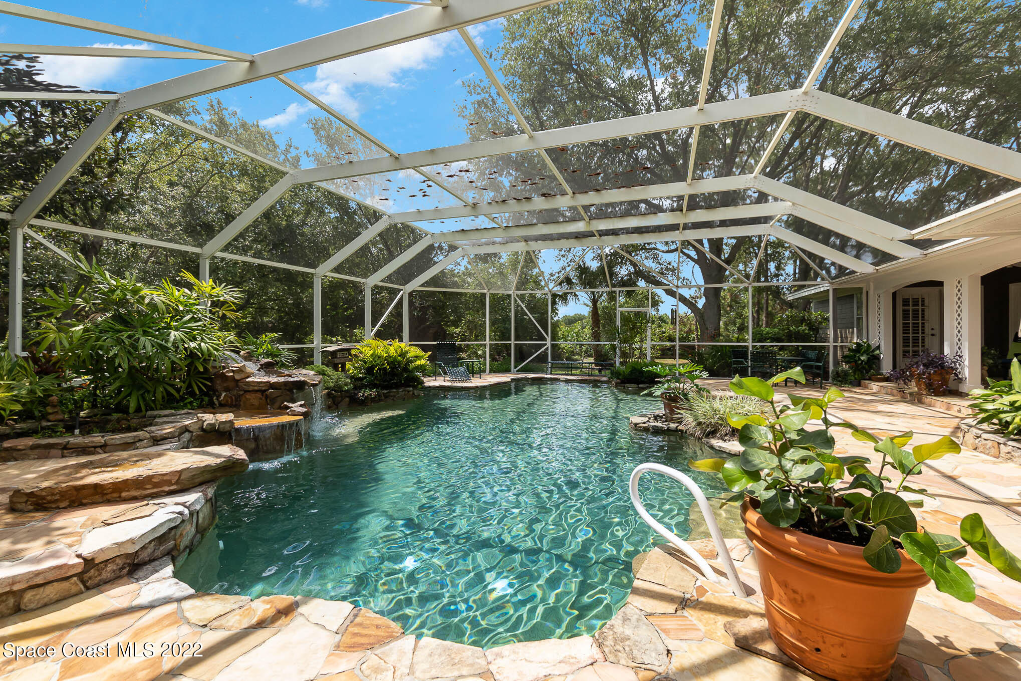 4025 Turtle Mound Road Melbourne, FL 32934 - Photo 22 of 54 a view of a chair and tables in the patio