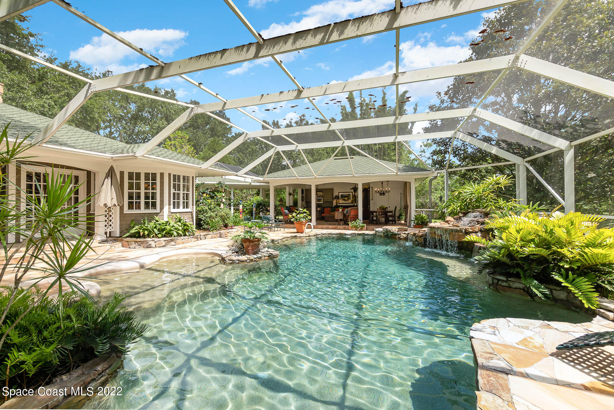4025 Turtle Mound Road Melbourne, FL 32934 - Photo 24 of 54 a view of a house with backyard sitting area and garden