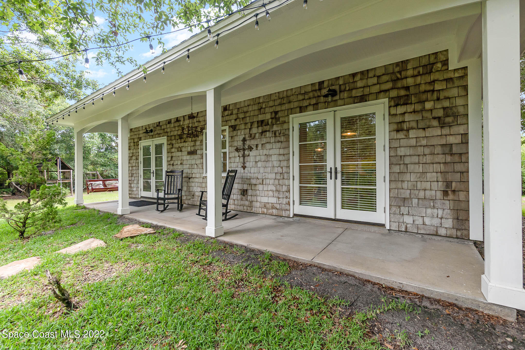 4025 Turtle Mound Road Melbourne, FL 32934 - Photo 27 of 54 a view of a house with backyard and porch