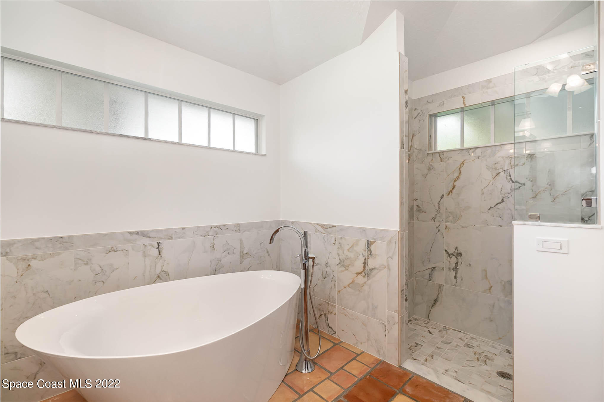 4025 Turtle Mound Road Melbourne, FL 32934 - Photo 36 of 54 a bathroom with a bathtub and shower