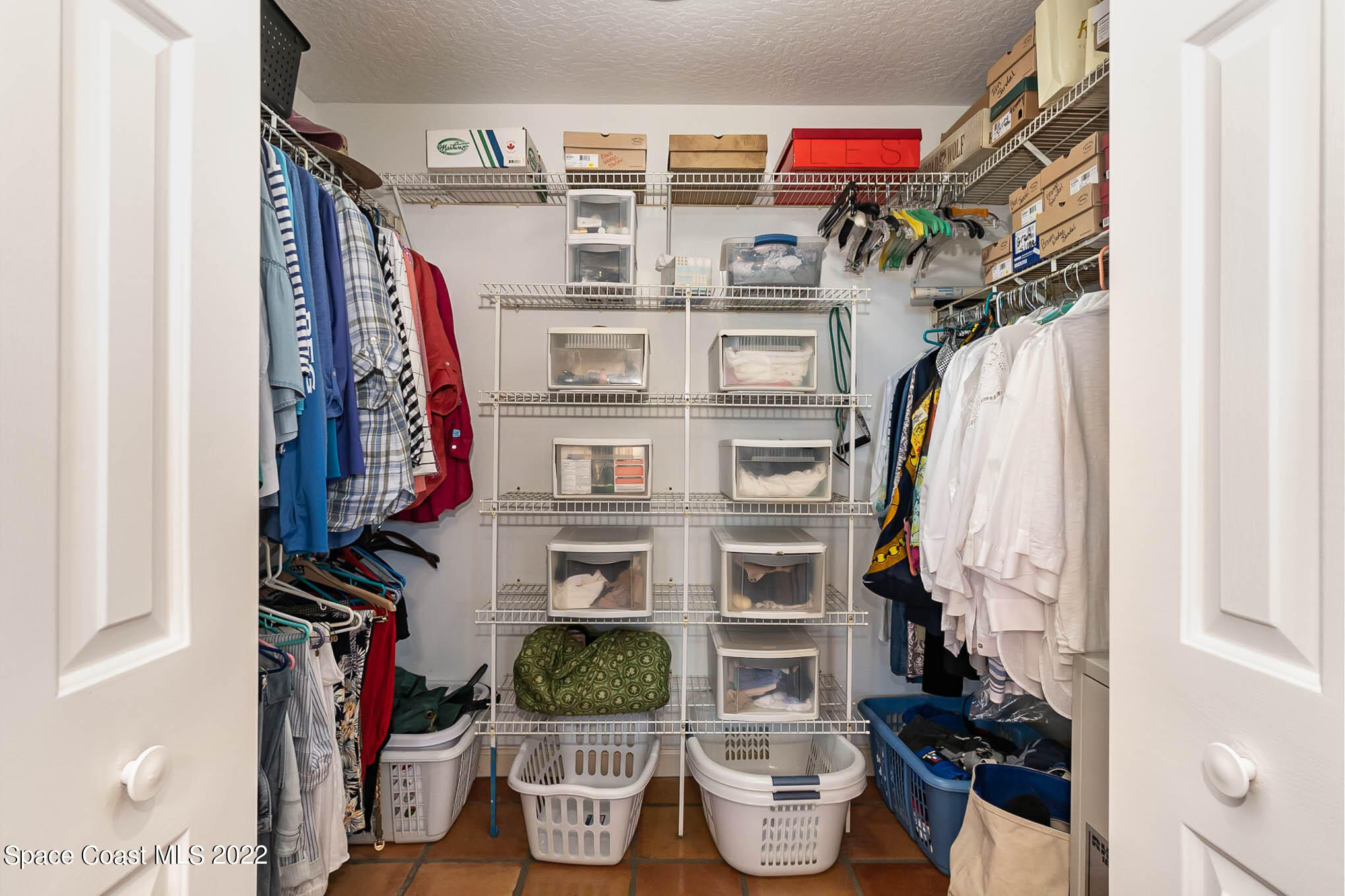 4025 Turtle Mound Road Melbourne, FL 32934 - Photo 38 of 54 a view of walk in closet with clothes and shoes