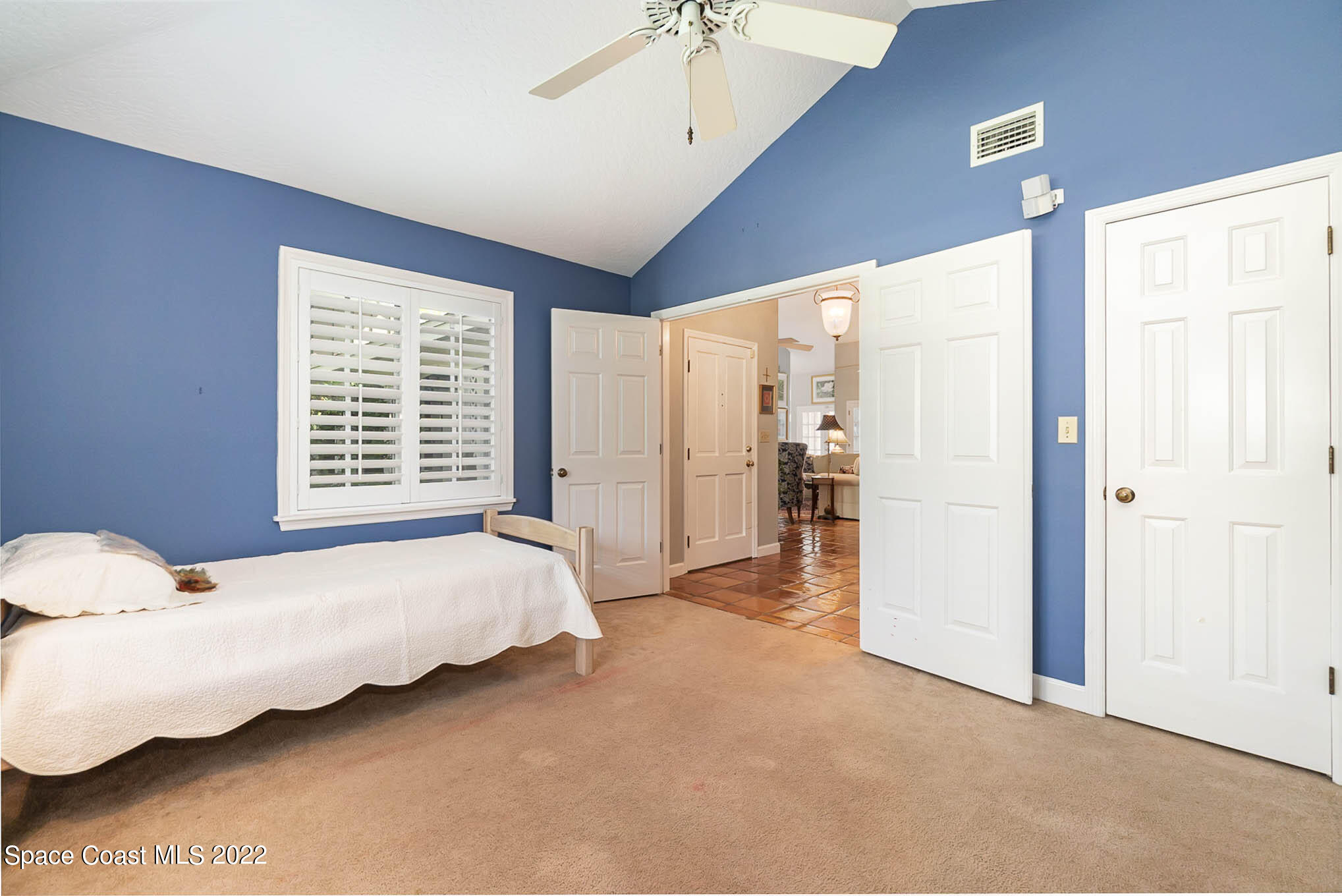4025 Turtle Mound Road Melbourne, FL 32934 - Photo 39 of 54 a spacious bedroom with a bed and a chandelier