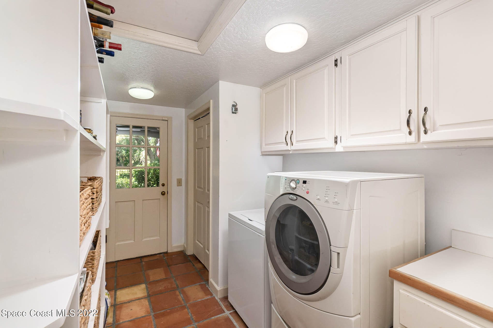 4025 Turtle Mound Road Melbourne, FL 32934 - Photo 42 of 54 a view of a storage and utility room with washer and dryer
