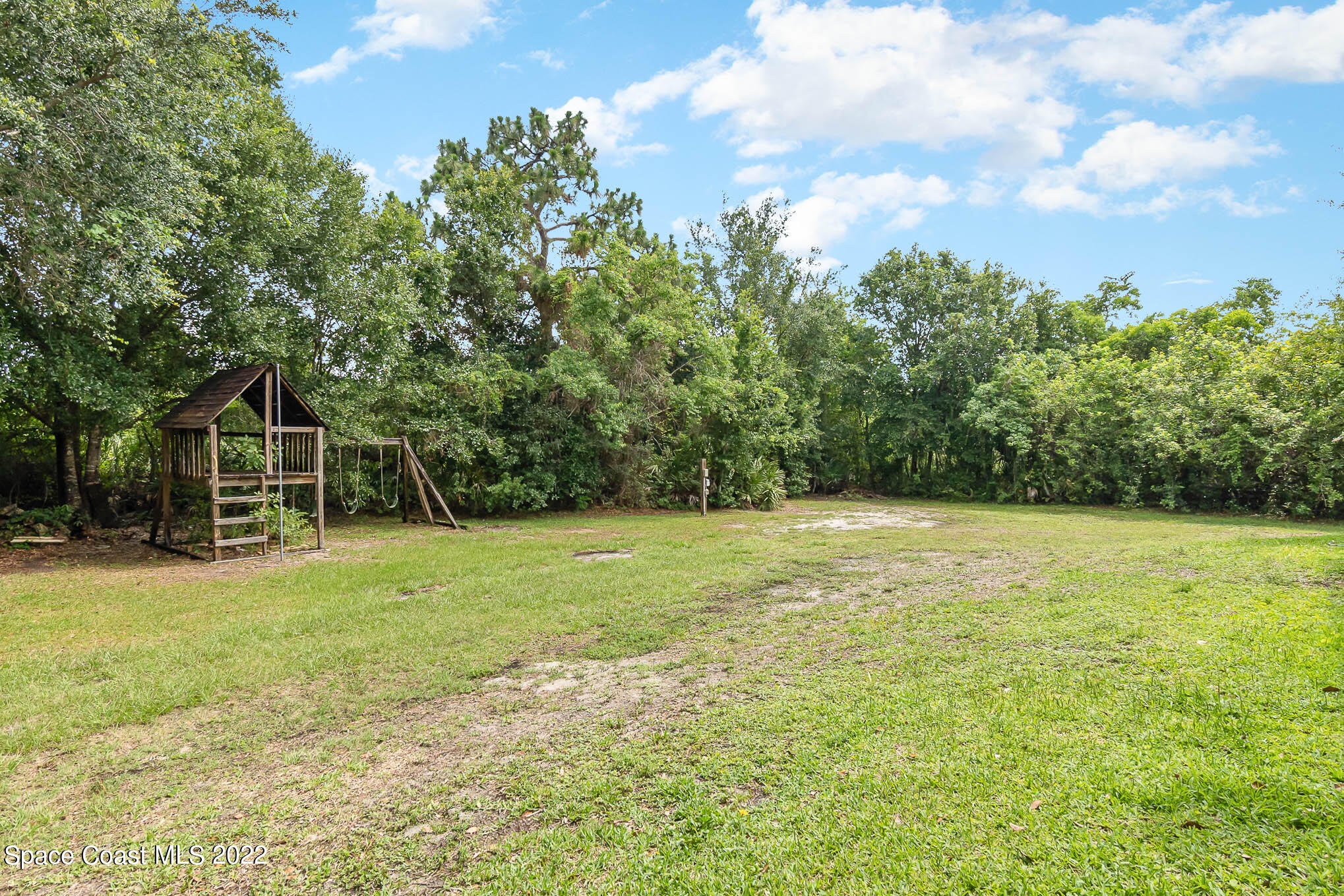 4025 Turtle Mound Road Melbourne, FL 32934 - Photo 49 of 54 a backyard of a house with lots of green space
