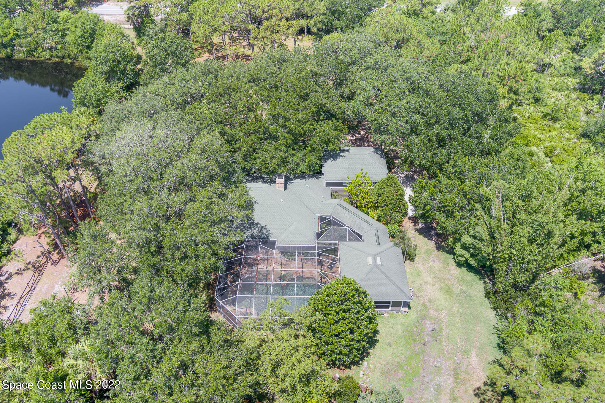 4025 Turtle Mound Road Melbourne, FL 32934 - Photo 52 of 54 a view of a house in a yard with large trees