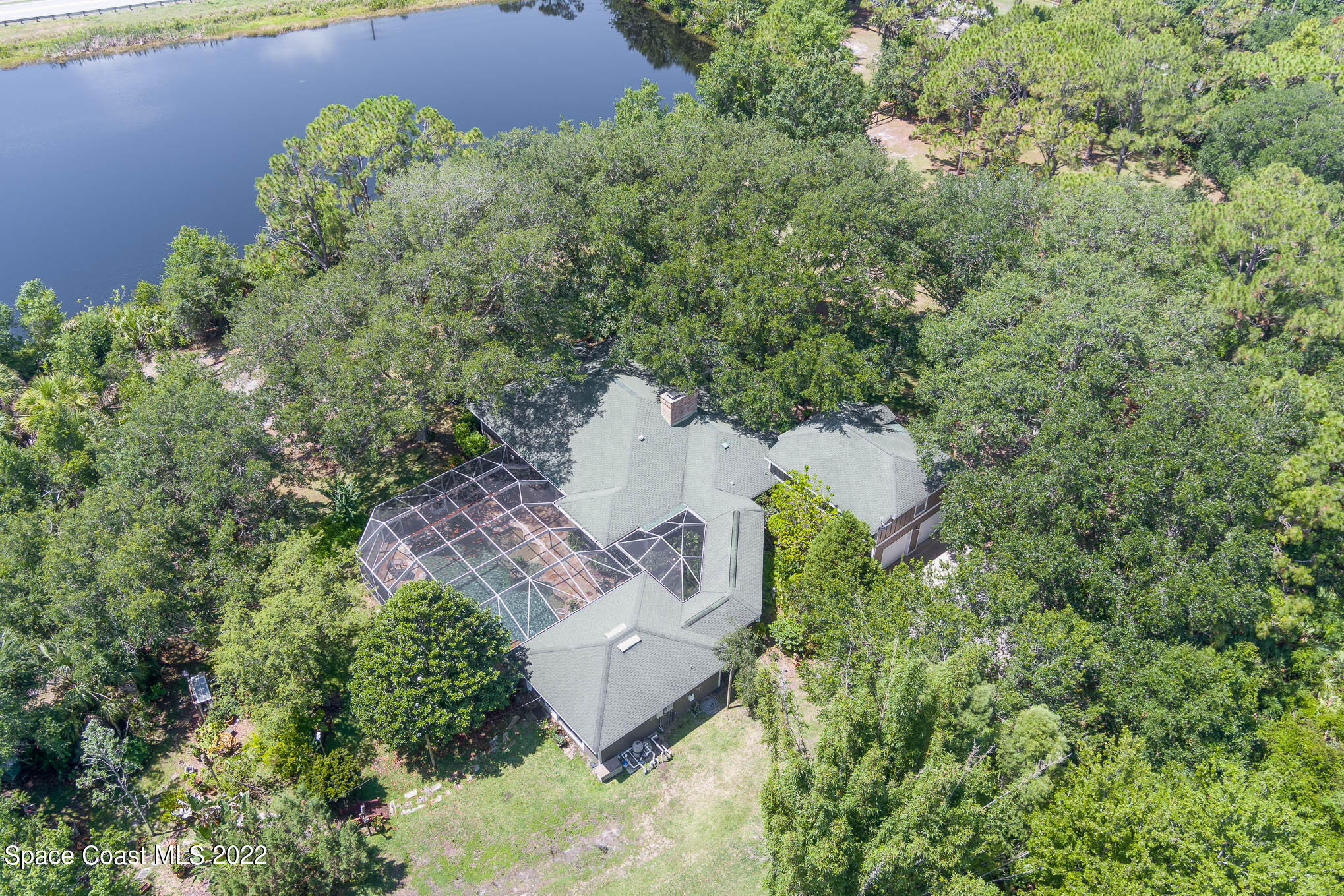 4025 Turtle Mound Road Melbourne, FL 32934 - Photo 53 of 54 an aerial view of a house with a yard and covered with trees