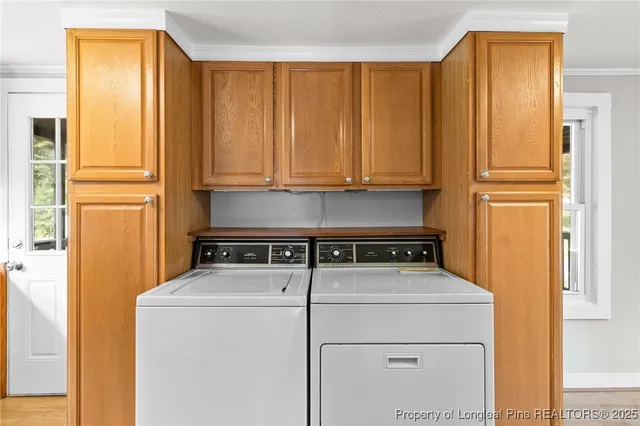 a view of washer and dryer with wooden floor