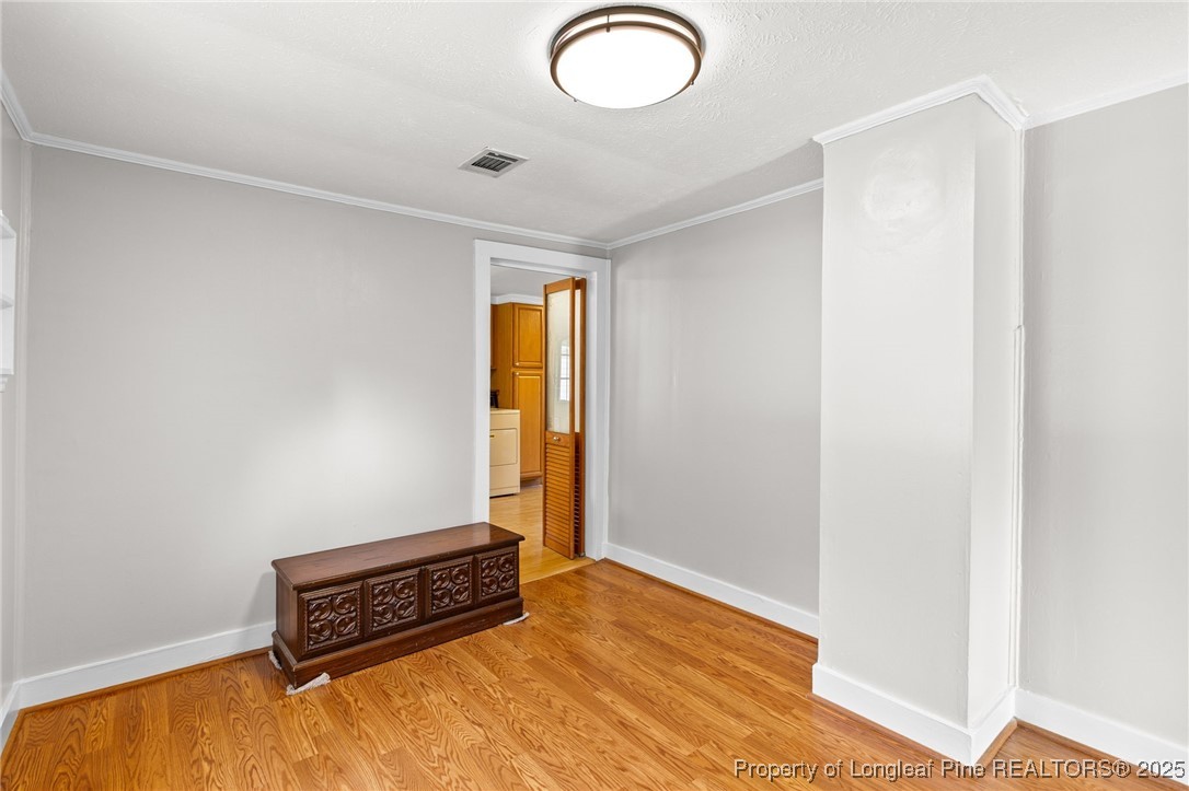21480 Jane Shaw Road Wagram, NC 28396 - Photo 18 of 31 a view of room with window and wooden floor