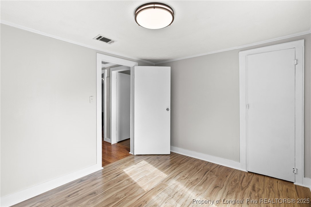 21480 Jane Shaw Road Wagram, NC 28396 - Photo 23 of 31 an empty room with wooden floor and windows