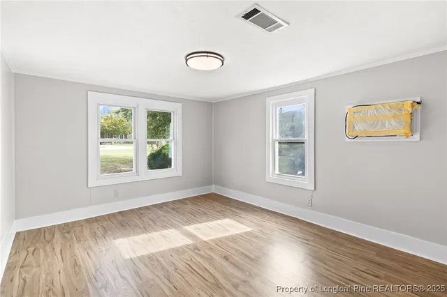 wooden floor in an empty room with a window