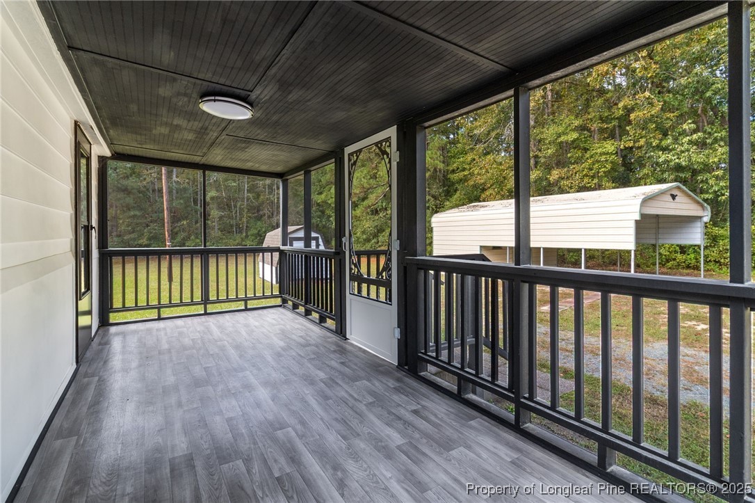 21480 Jane Shaw Road Wagram, NC 28396 - Photo 26 of 31 a view of a room with wooden floor and stairs