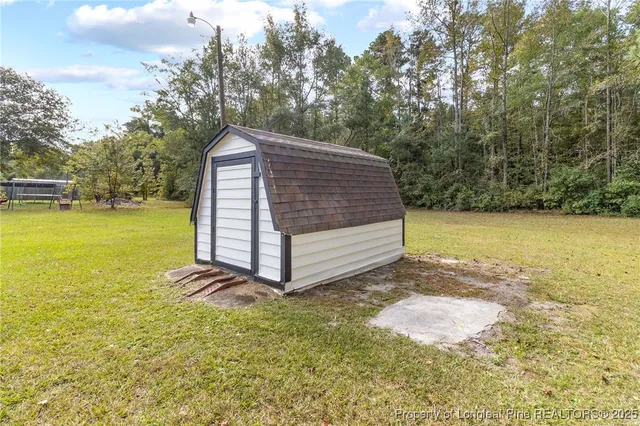 a view of a backyard with large trees