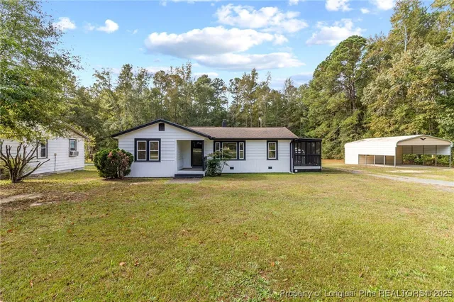 a big house with a big yard and large trees