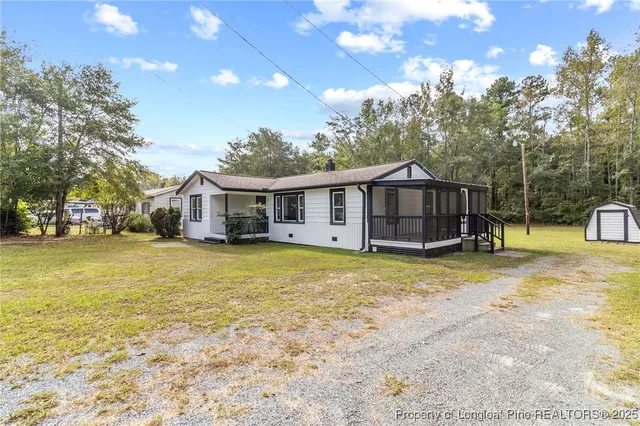 a view of a house with pool and sitting area