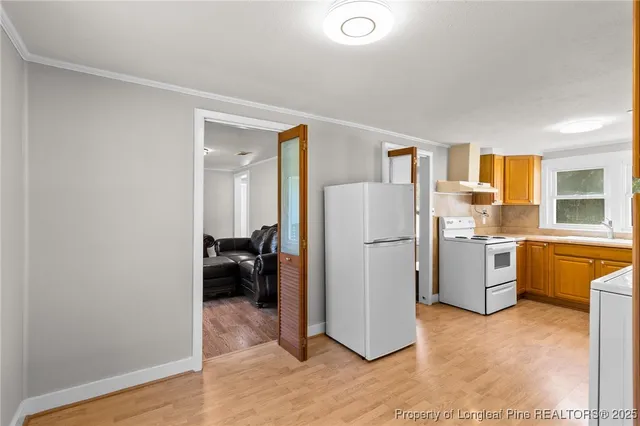 a kitchen with a refrigerator and a stove