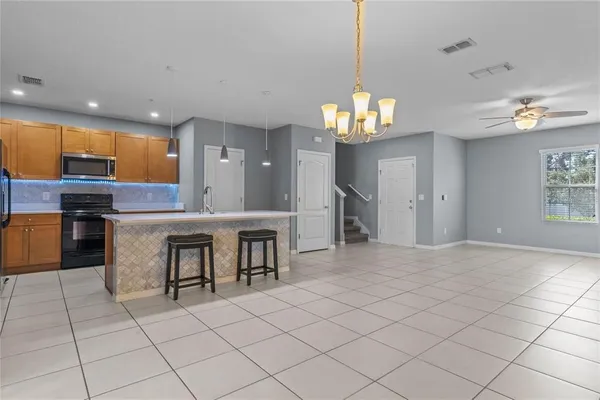 a view of kitchen with granite countertop cabinets a sink and a counter top space
