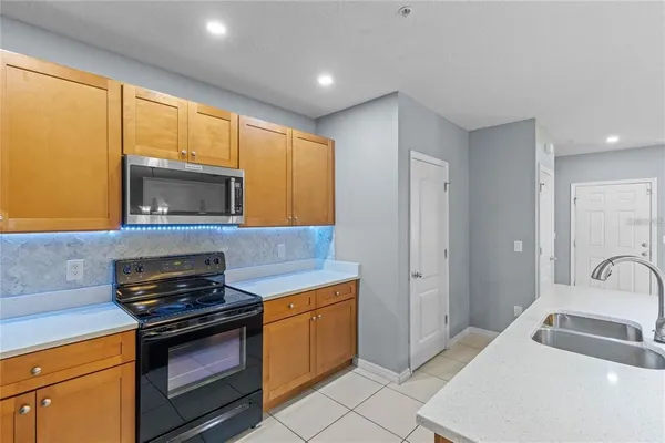 a kitchen that has a sink and a stove top oven