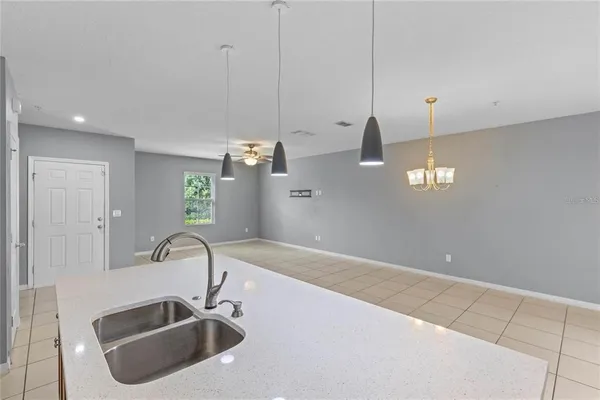 a kitchen with a sink and chandelier