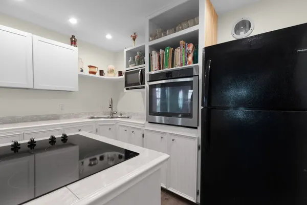 a kitchen with a sink a stove and cabinets