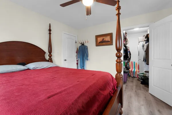 a bedroom with a bed and a chandelier
