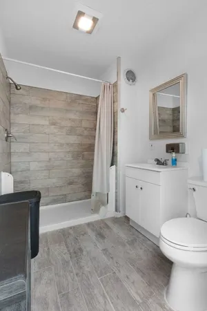 a bathroom with a toilet a sink and bathtub