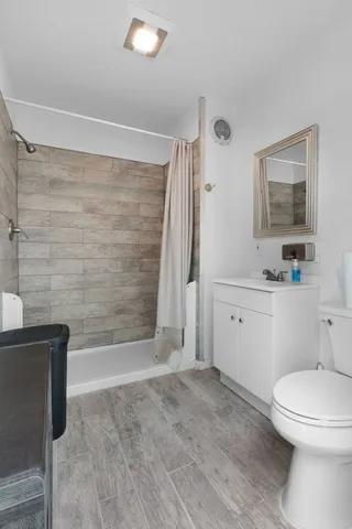 a bathroom with a toilet a sink and bathtub