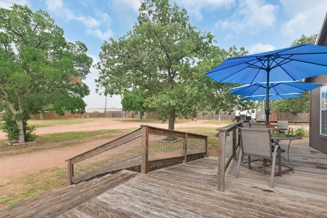a view of backyard with outdoor seating and trees