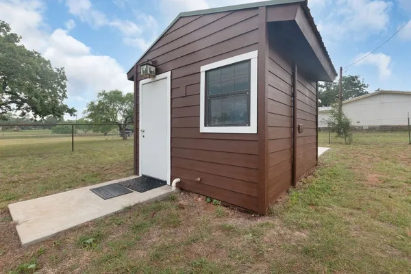 a view of a backyard with plants and a lake view