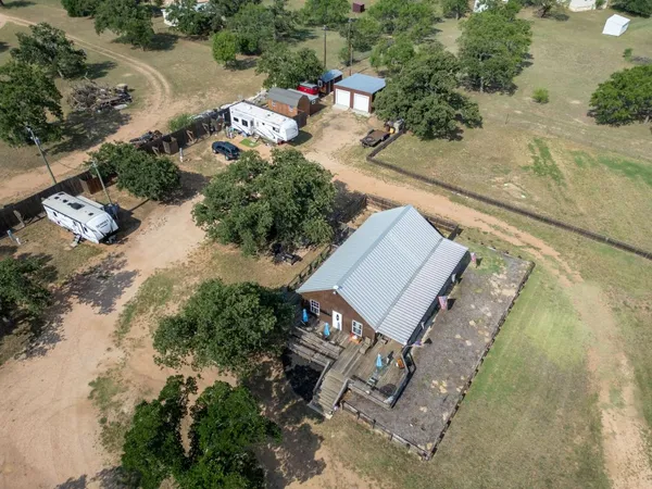 an aerial view of a house with a yard