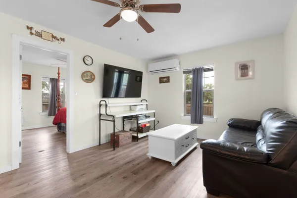 a living room with furniture and a wooden floor