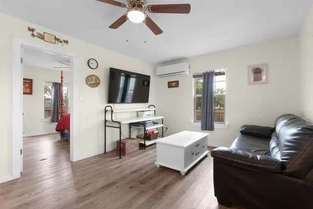 a living room with furniture and a wooden floor