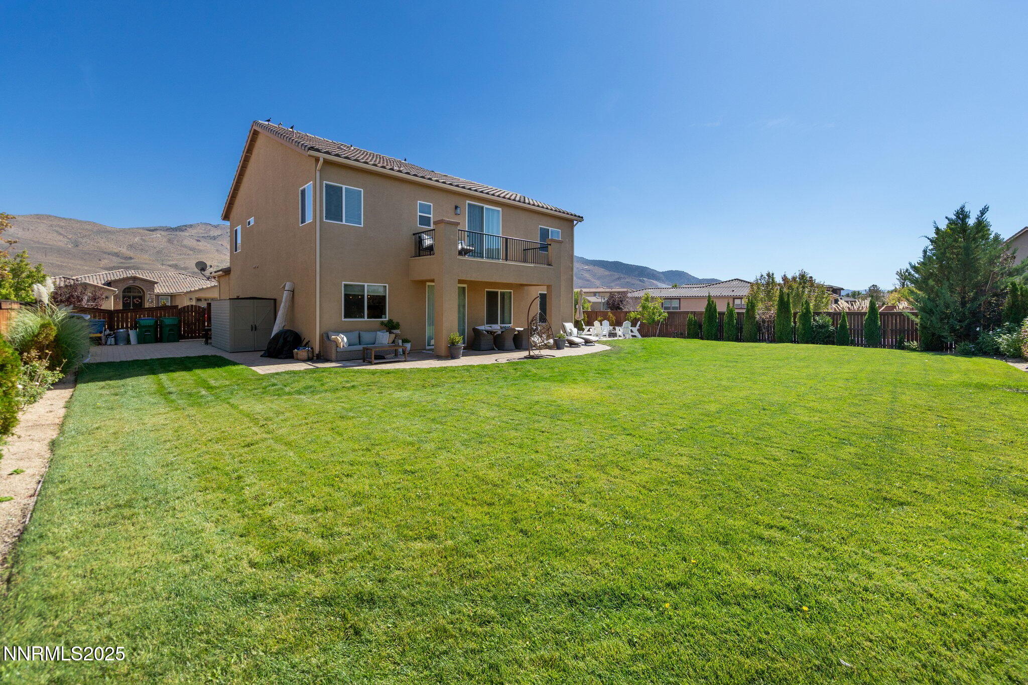 9845 Copenhagen Way Reno, NV 89521 - Photo 11 of 57 a large house with a big yard and large trees
